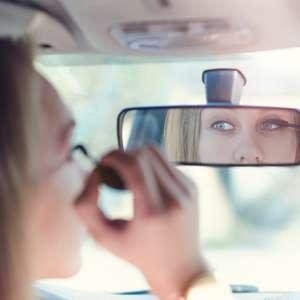Sjåfør sminker seg bak rattet
