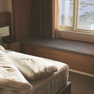 En uoppredd seng på soverom om morgenen (Foto)